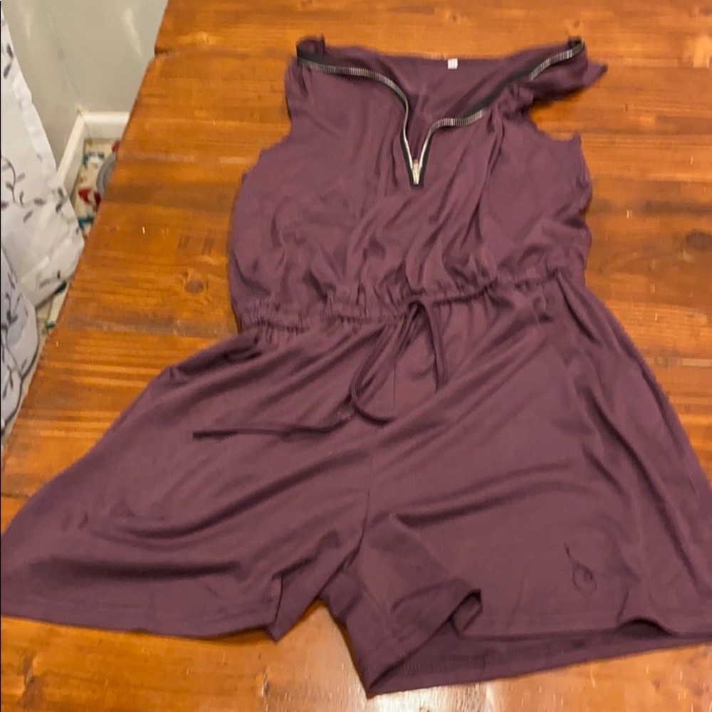 Brand new purple romper with pockets size M